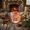 Ceramic Petra souvenir ornament styled on a rustic table next to decorative pinecones and a candle.