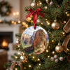Zion National Park holiday keepsake hanging among glowing lights on an evergreen tree branch.