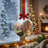 Festive Zion Canyon decoration catching natural daylight while hanging in front of a frosty window.