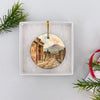 Open white gift box displaying the round ceramic Pompeii souvenir ready for holiday giving.