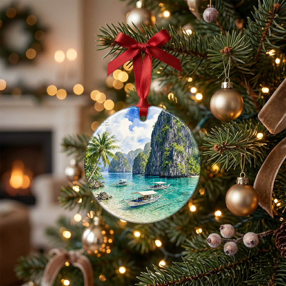 Ceramic Palawan holiday keepsake suspended from a brightly lit Christmas tree branch.
