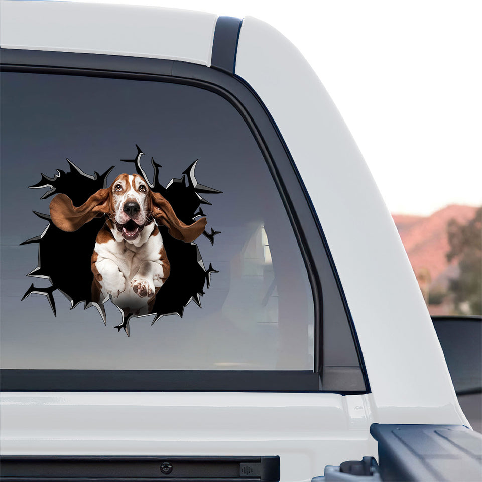 Glossy Basset Hound decal decorating the rear glass of a truck outdoors.