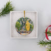 Round ceramic travel keepsake tucked securely inside an opened white gift box packaging