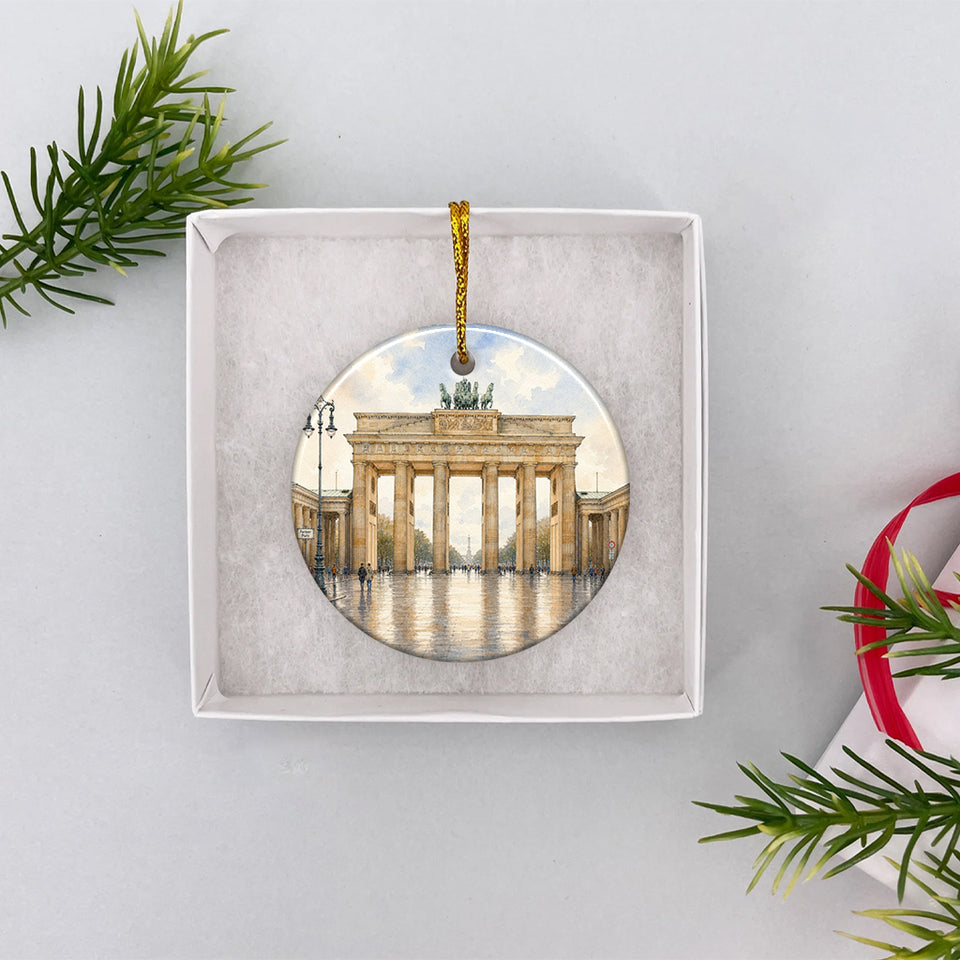 Round ceramic Berlin souvenir nestled inside an open white gift box ready for Christmas giving.