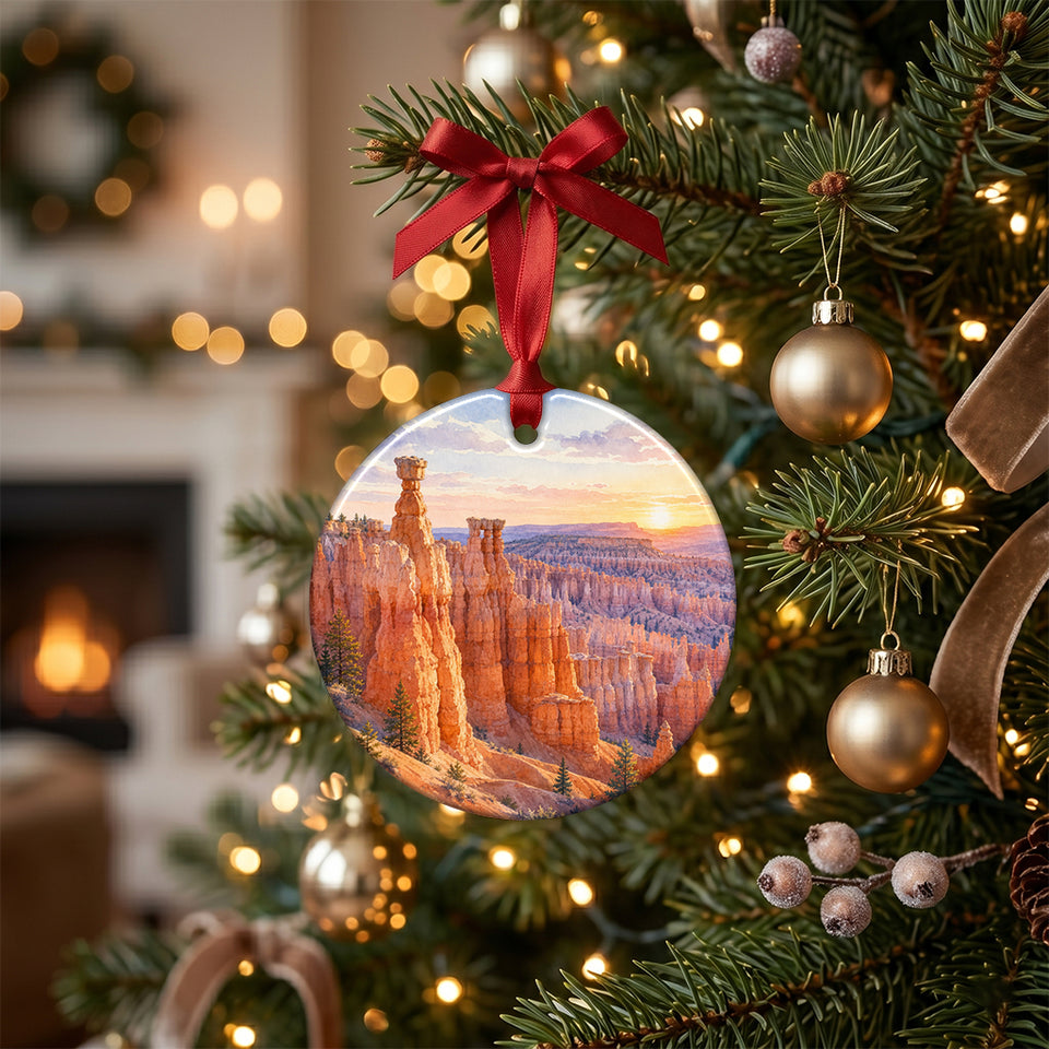 Holiday tree branch holding the ceramic Bryce Canyon ornament amid glowing festive lights