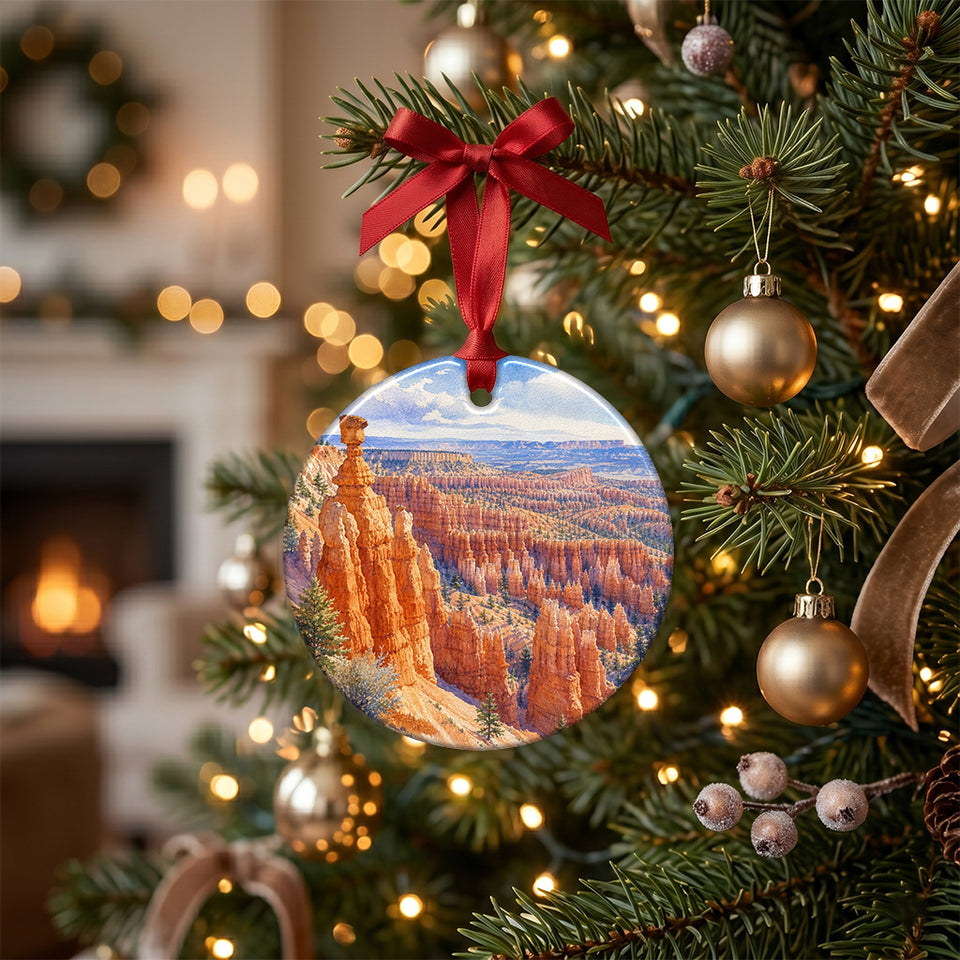 Ceramic Bryce Canyon keepsake hanging from a green holiday tree branch with glowing lights.