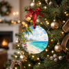 Holiday tree branch decorated with a ceramic ornament depicting the sunny Cancún coastline.