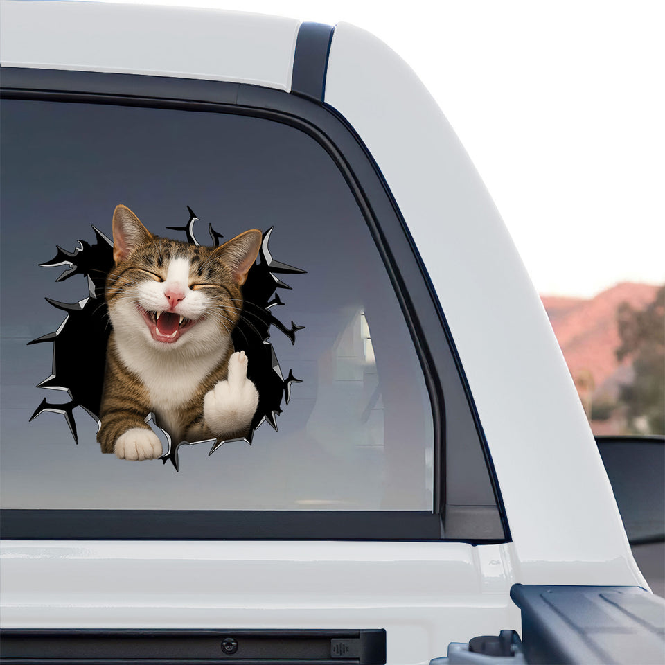 Playful feline peeking sticker applied on the side window of a truck outdoors.