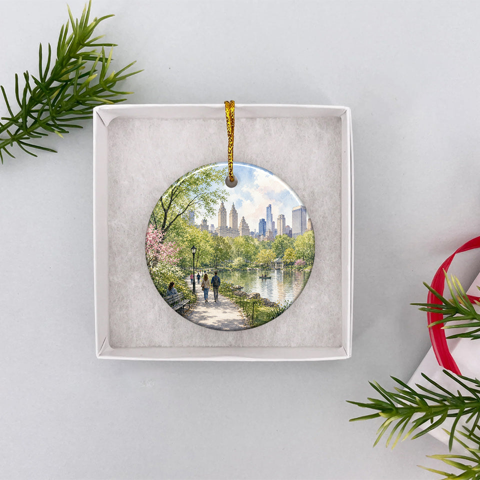 Round ceramic NYC holiday ornament presented neatly inside an opened white gift box ready for giving.