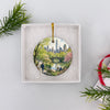Round Central Park ornament presented inside an open white gift box.