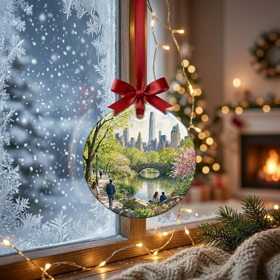 NYC souvenir ornament hanging in front of a frosty winter window in soft daylight.