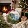 Round ceramic Ireland ornament sitting beside wrapped holiday gifts near a cozy fireplace.