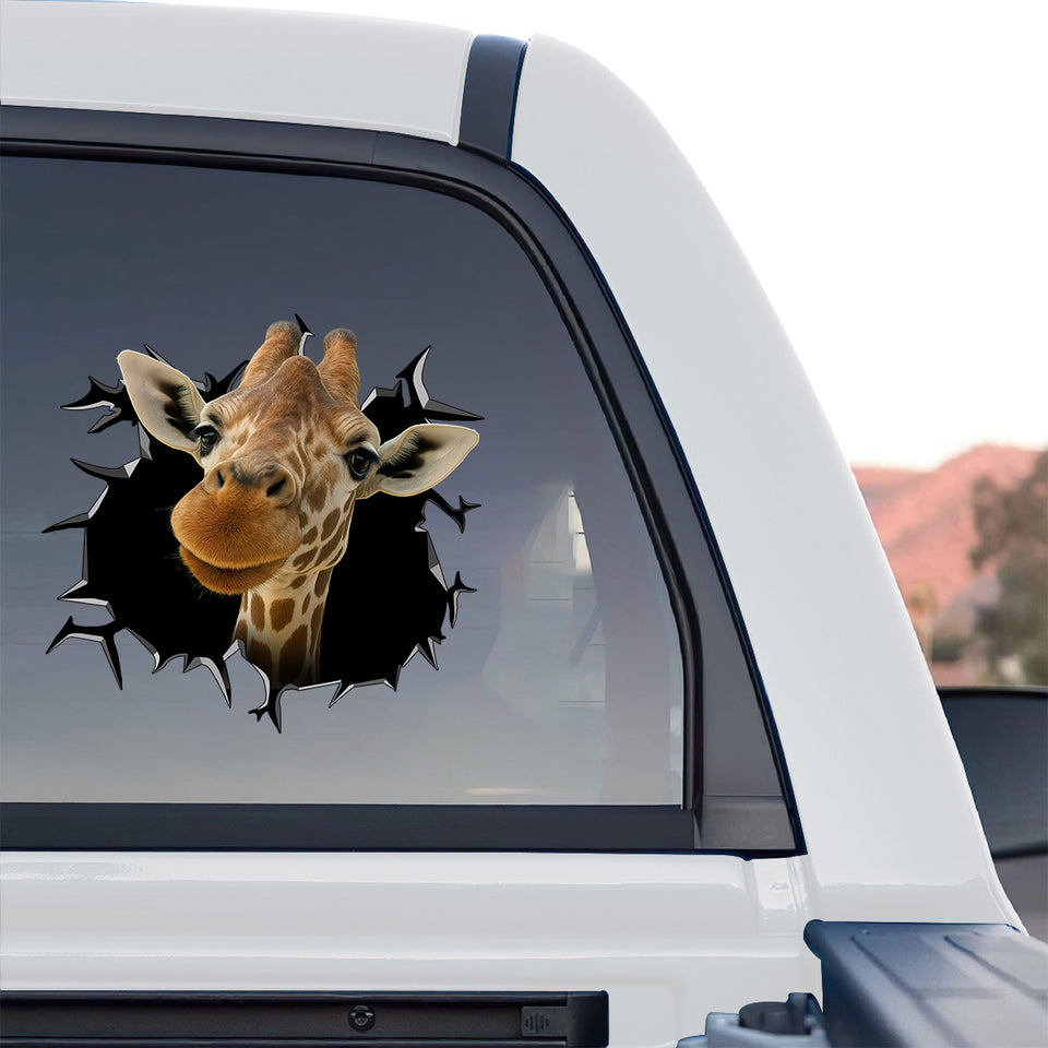 Glossy giraffe vinyl sticker displayed on the rear window of a truck.
