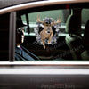 Clear outdoor deer sticker cleanly applied to a black car door exterior.