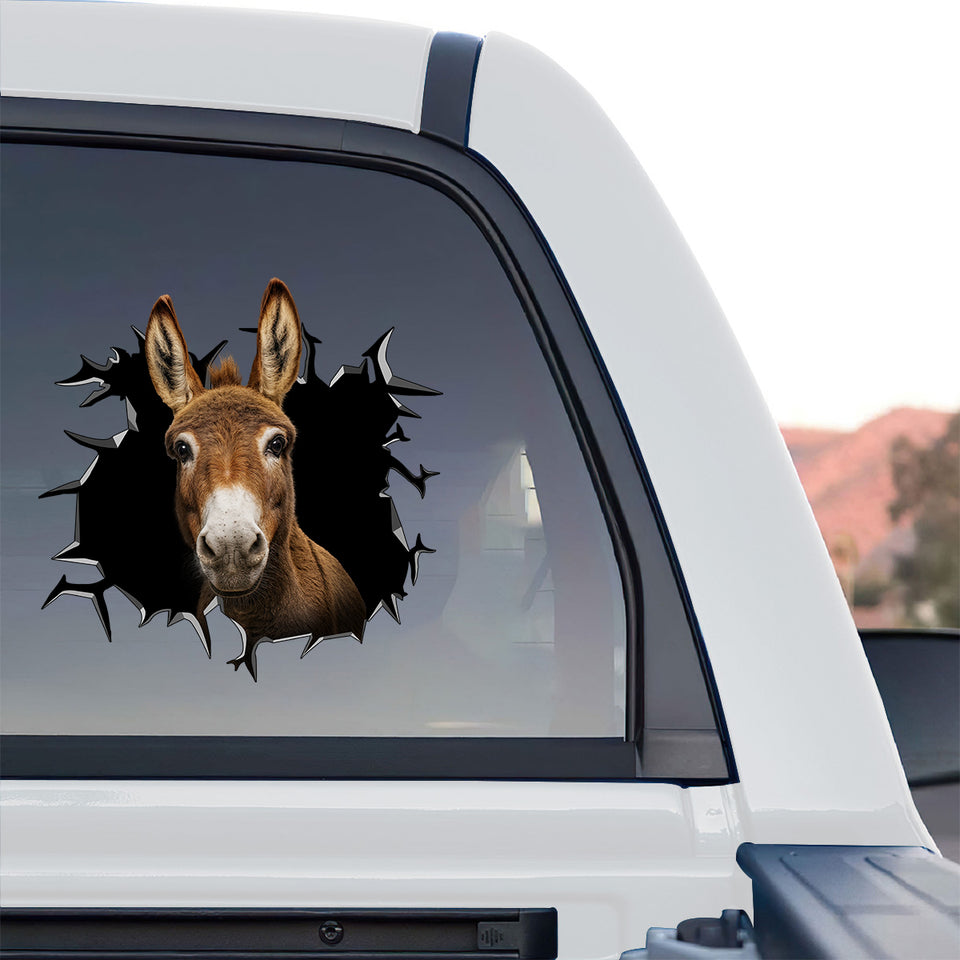 Glossy Donkey farm animal sticker displayed on the rear window of a truck outdoors.