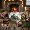 Festive Edinburgh ornament arranged on a rustic table alongside scented pinecones and a candle.