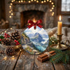 Holiday ornament styled across a rustic tabletop beside seasonal pinecones.