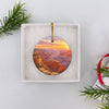 Southwest travel ornament resting securely inside an opened white gift box ready for holiday gifting.