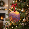 Ceramic canyon vista ornament hanging from an illuminated branch of a decorated holiday tree.