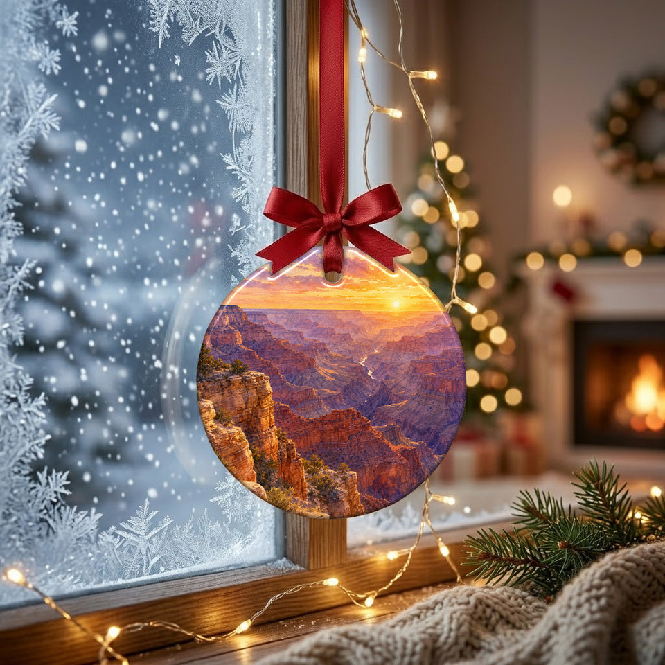 Round canyon sunrise ornament suspended before a frosty winter window catching gentle daylight.