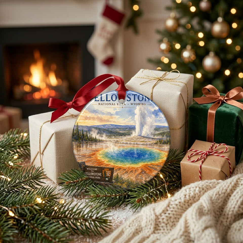 Festive Grand Prismatic Spring ornament resting next to wrapped holiday gifts near a warm fireplace.