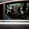 Great Dane graphic sticker applied smoothly onto the side car door of a white commuter vehicle.