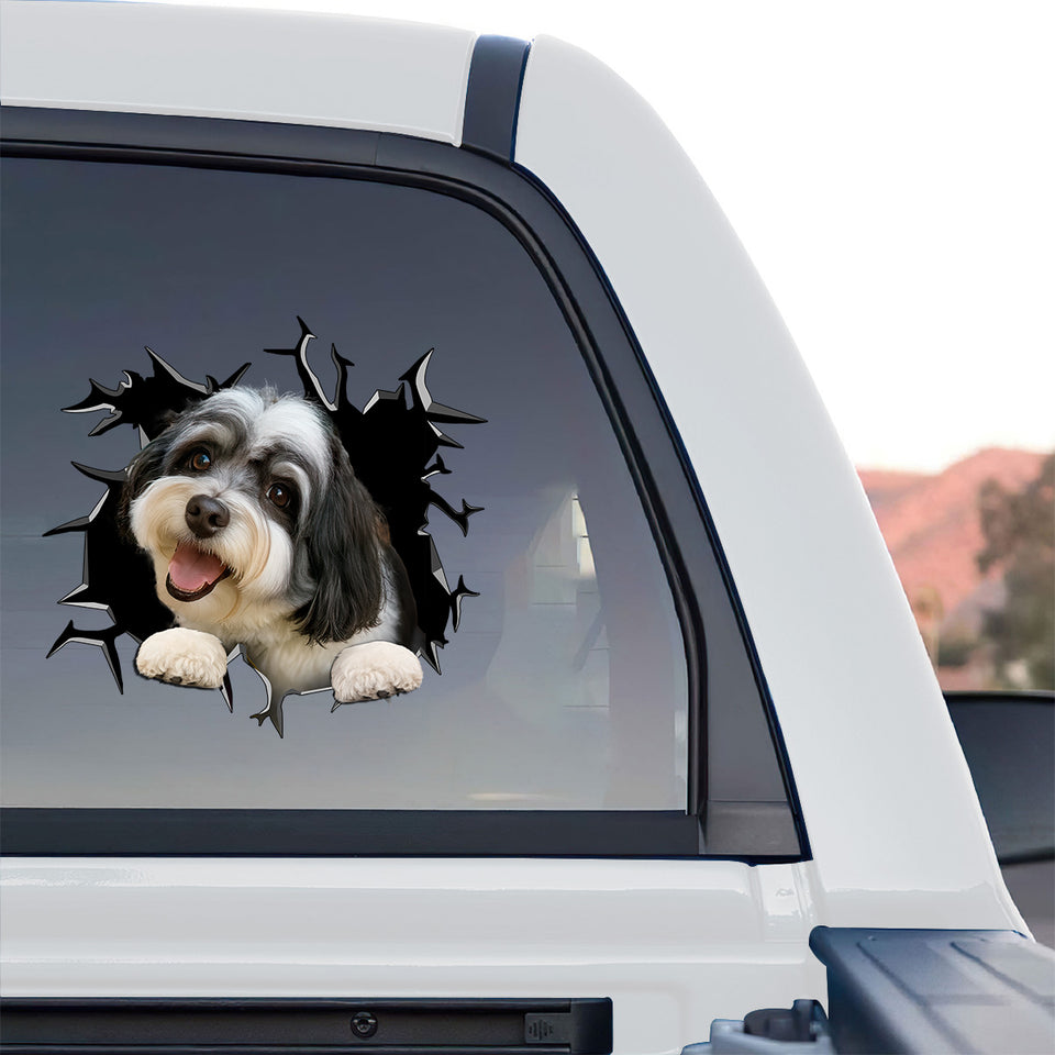 Waterproof dog sticker adhered smoothly to the rear window of a truck.