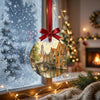 Detailed Belgian travel ornament hanging in front of a frosted winter window in soft natural daylight.