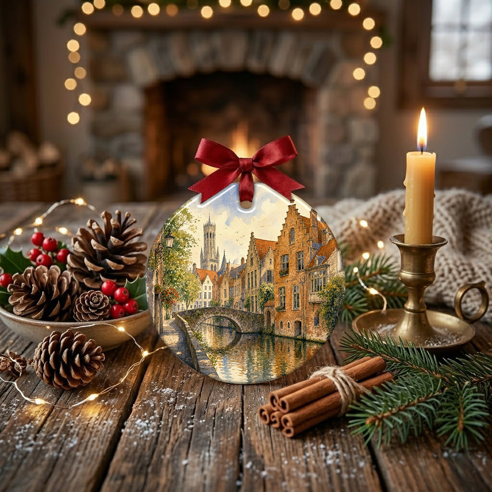 Round ceramic Bruges keepsake showcased on a rustic table alongside a glowing candle and pinecone accents.