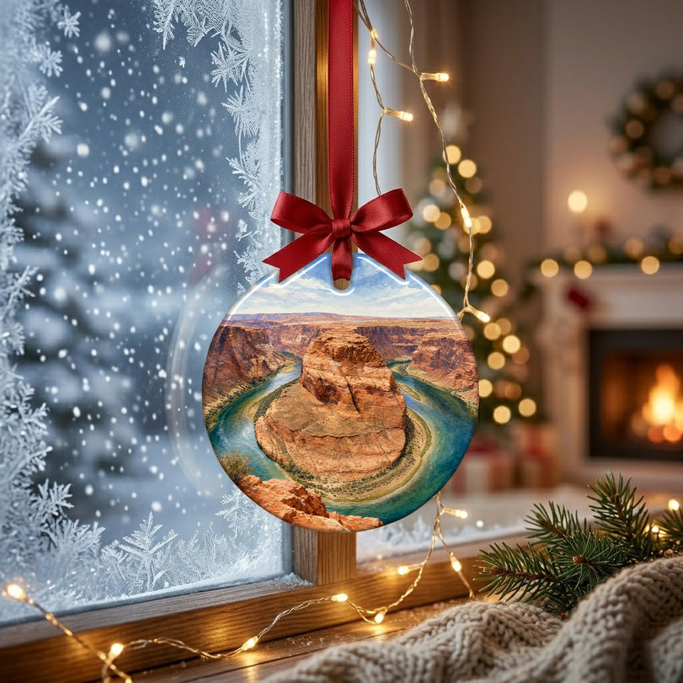 Travel souvenir ornament hanging in front of a frosty winter window in soft daylight.