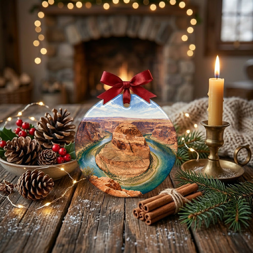 Festive desert holiday ornament styled on a rustic table alongside pinecones and a candle.