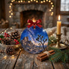 Ceramic travel keepsake styled on a rustic tabletop alongside natural pinecones and festive candlelight.