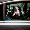 Glossy black dog decal applied smoothly on a white car door exterior.