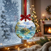 Holiday decoration of Slovenia's Lake Bled suspended in front of a frosty winter window.