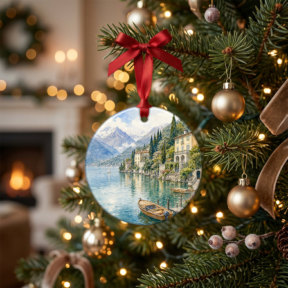 Round ceramic Italian keepsake hanging from a lit pine branch on a Christmas tree.