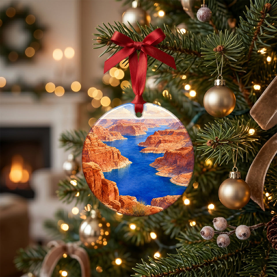 Ceramic Lake Powell holiday ornament hanging gently from the branch of a lit Christmas tree.