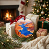 Southwest canyon ornament displayed beside wrapped holiday gifts in front of a glowing fireplace.