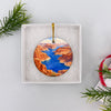Round ceramic Lake Powell keepsake nestled inside an opened white gift box ready for holiday gifting.