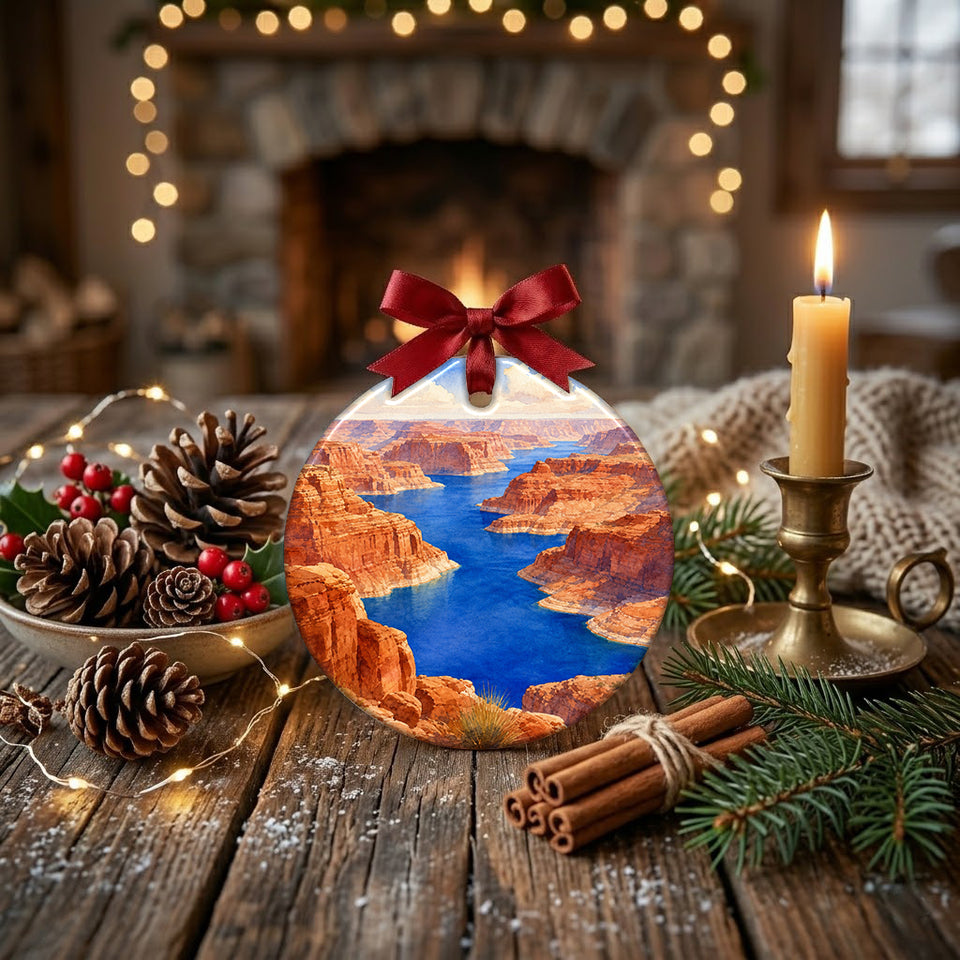 Desert lake holiday keepsake arranged on a rustic tabletop beside pinecones and a glowing candle.