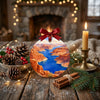 Desert lake holiday keepsake arranged on a rustic tabletop beside pinecones and a glowing candle.