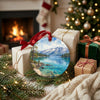 Round alpine lake keepsake displayed near wrapped holiday gifts and a warm glowing hearth.