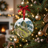 Ceramic Machu Picchu holiday ornament hanging from an illuminated Christmas tree branch.