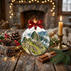 Holiday ornament resting on a rustic tabletop accompanied by seasonal pinecones and candlelight.