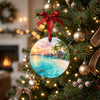 Tropical island holiday decoration hanging from a branch of a lit evergreen Christmas tree.