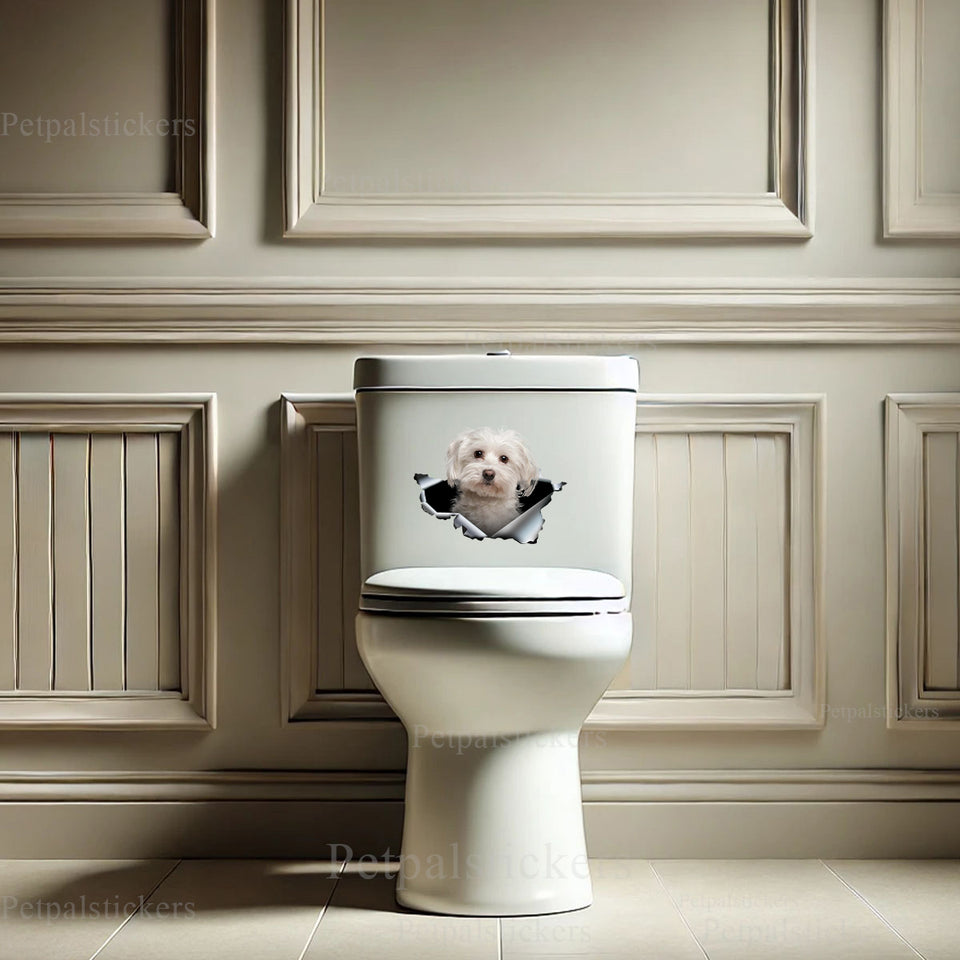 Playful Maltese puppy vinyl decal placed on a smooth white toilet tank surface.