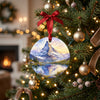 Alpine ceramic keepsake hanging on an illuminated Christmas tree branch among festive holiday lights.