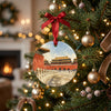 Beijing palace holiday keepsake hanging from a pine branch on a brightly lit Christmas tree.