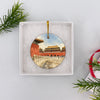 Holiday travel keepsake tucked safely inside an opened white gift box ready for seasonal gifting.