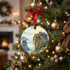 Holiday ornament featuring Greek cliffside monasteries hanging from a lit Christmas tree branch.