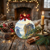 Festive holiday display on a rustic table accented with natural pinecones and a glowing candle.